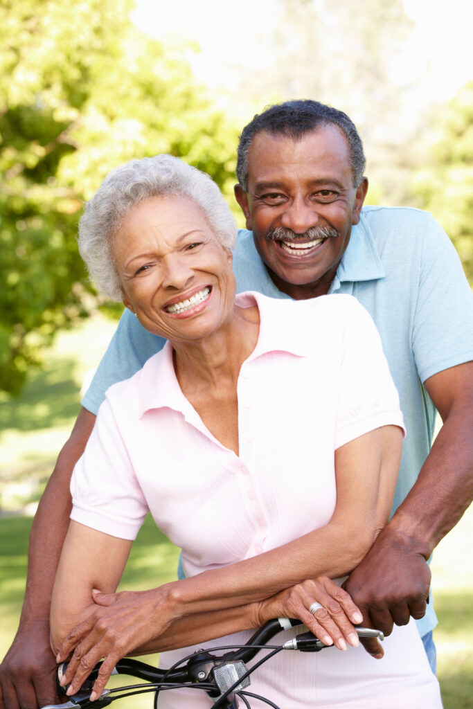 Smiling african american couple on a bike